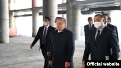 Президент Узбекистана Шавкат Мирзияев и самаркандский олигарх Бахтиёр Фазылов (справа) знакомятся со строительными работами в аэропорту Самарканда, 15 апреля 2021 года. Фото: Пресс-служба президента.