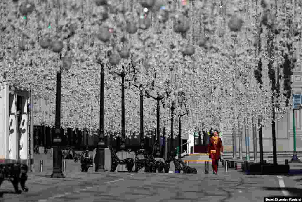 A woman walks along a decorated street in Moscow. (Reuters/Shamil Zhumatov)