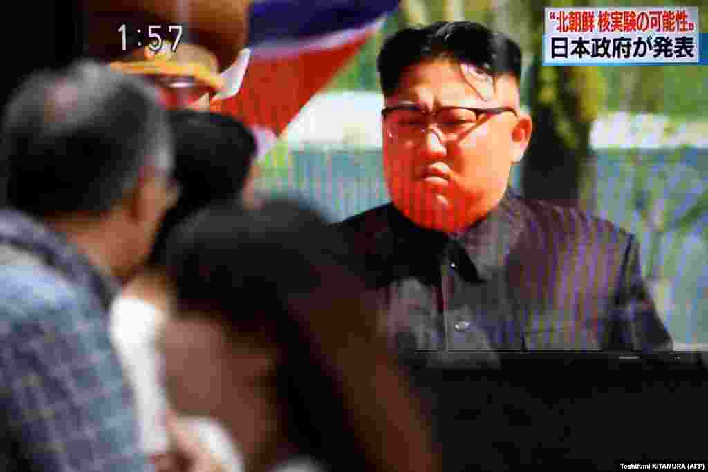 Pedestrians walk past a television screen showing a news program on a possible North Korean nuclear test in Tokyo on September 3 after North Korea appeared to carry out a sixth nuclear test. (AFP/Toshifumi Kitamura)