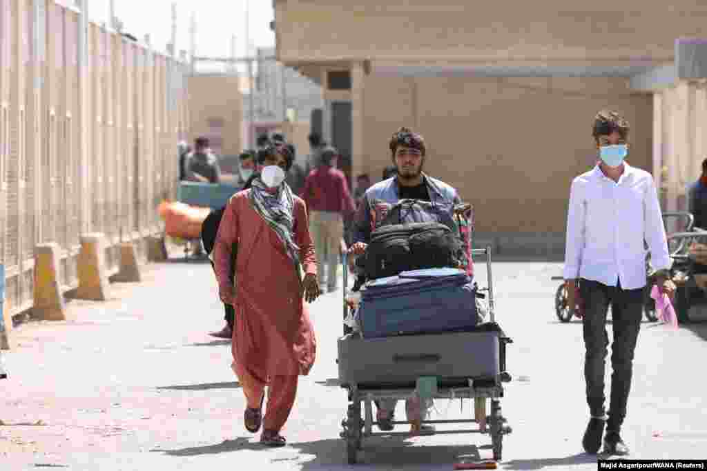 Afghans enter Iran at the Dowqarun border crossing on August 29.