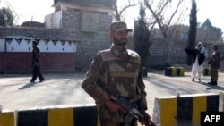 An army soldier stands near the World Food Program distribution point hit by a female suicide bomber in Khar, Pakistan.