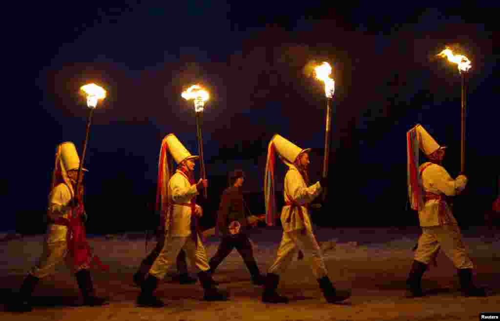 Belarusians perform during a celebration of the Tsary rite in the village of Semezhevo, some 145 kilometers south of Minsk. This unique rite originated in the 18th century and now takes place only in this village. It marks the New Year according to the Julian calendar. (Reuters/Vasily Fedosenko)