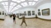 A gold-painted art lover who was wearing only a red thong strolled through the Tretyakov Gallery in Moscow on March 20.