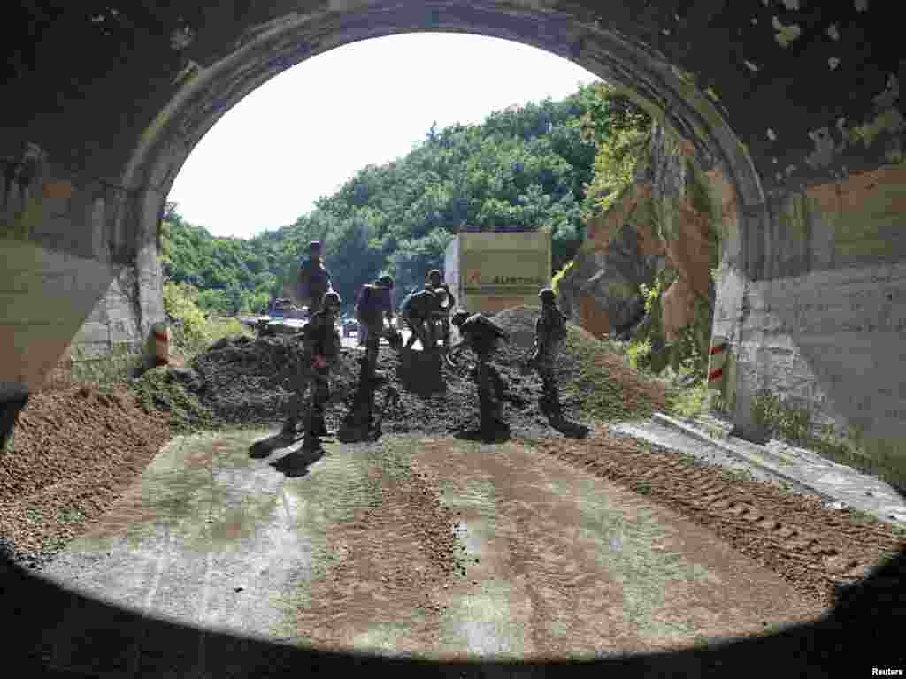 Members of the French KFOR clear a barricade near the northern Kosovo village of Zubin Potok on July 26 after Kosovo sent special police forces to its Serbian-populated north late on Monday to enforce a ban on imports from Serbia and local Serbs resisted the move. Photo by Marko Djurica for Reuters