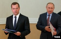 Russian President Vladimir Putin (right) and Prime Minister Dmitry Medvedev arrive at a Security Council session held in Sevastopol, Crimea, on August 19.