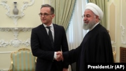 Iranian President Hassan Rohani meets with German Foreign Minister Heiko Maas earlier this year.