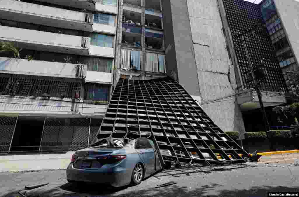 MEXICO -- A damaged car is seen outside a building after an earthquake in Mexico City, Mexico September 19, 2017