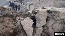 Afghan villagers gather at the site of a landslide in the Argo district of Badakhshan Province on May 2.