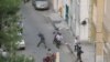 Members of Baseej militia throw stones during post-election protests in Tehran, June, 2009