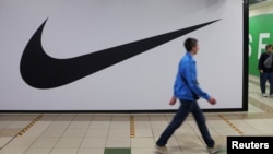 People walk past a closed store of Nike in St. Petersburg on May 25.