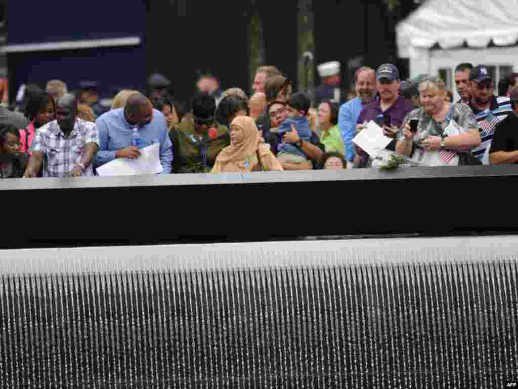 Family members who lost loved ones gather at the North pool of the 9/11 Memorial during 10th anniversary ceremonies at the site of the World Trade Center in New York.