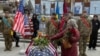 Leslie and John Hertweck pay their respects in Kyiv at the coffin of their son, Ethan, a U.S. Marine Corps veteran who died while working as volunteer combat medic for Ukraine. 