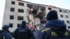 Ukrainian rescuers work at the site of a heavily damaged building following an air attack in Zaporizhzhya on October 30. 