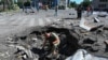TOPSHOT - A bomb technician works at the site of a destroyed residential building following an aerial bomb in the centre of Kharkiv, on June 22, 2024, amid the Russian invasion of Ukraine. (Photo by SERGEY BOBOK / AFP)