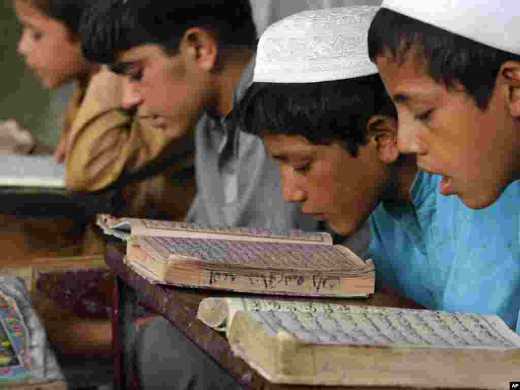 Afghan boys read the Koran at a mosque in the city of Jalalabad, the provincial capital of Nangarhar Province, east of Kabul. Photo by Rahmat Gul for AP