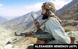 A Taliban fighter from Tajikistan guards a position in northern Afghanistan.