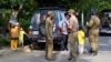 Police officers search a car at a temporary checkpoint around the home of Pakistani former Prime Minister Imran Khan in Lahore on May 17. 