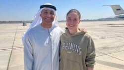 Ksenia Karelina (right) poses for a photo with UAE Ambassador to the US Yousef al-Otaiba following her release at an airport in Abu Dhabi on April 10. 
