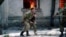 Abkhazia -- An Abkhaz militiaman evacuates a boy during the Abkhazian war. September 28, 1993