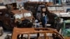 People walk among a display of destroyed Russian military machinery in downtown Kyiv on October 22. 