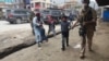 An Afghan soldier walks civilians to safety during an attack on a Sikh temple in Kabul on March 25.