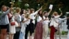 Women hold flowers during a demonstration in Minsk on August 20 against violence following recent protests to reject the presidential election results.