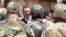 Syrian President Bashar al-Assad greets Syrian army soldiers in Daraya on August 1.