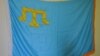 Крымско-татарский флаг на стене в Меджлисе