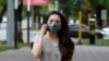 Kazakhstan. A girl in a protective mask is walking along the street of Almaty. June 22, 2020