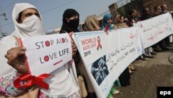 FILE: People hold placards during a rally to create awareness about HIV/AIDS. 