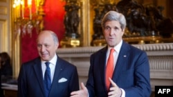 France -- US Secretary of State John Kerry (R) talks with French Foreign Minister Laurent Fabius prior to their meeting at the French Foreign ministry, Quai d'Orsay, in Paris on January 13, 2014.