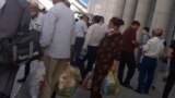 Turkmenistan. Man and woman with bags. Crowd of people. Turkmenbashi. August 2021 
