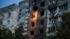 Ukrainian firefighters work at a site of an apartment building hit during a Russian drone strike on Kyiv on September 3. 