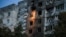 Ukrainian firefighters work at a site of an apartment building hit during a Russian drone strike on Kyiv on September 3. 