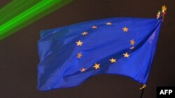 Ukraine -- A EU flag flies above Independence Square illuminated by green lights in central Kyiv, December 17, 2013