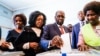 Zimbabwe-Former Zimbabwean president Robert Mugabe (C) his daughter Bona (C) and wife Grace cast their votes at a polling station at a primary school in the Highfield district of Harare during the country's general elections on July 30, 2018. Zimbabweans