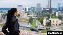 A file photo of a young woman looking out over Vilnius, Lithuania. 