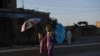 Afghan schoolgirls walk along a street on the outskirts of Mazar-e Sharif (file photo)