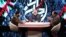 IRIB's controversial commentators Mohammad Sadegh Koushki (R) and Nader Talebzadeh (C), in a Jahanara program, produced by IRIB's Ofogh TV.