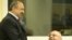 Bosnian Serb army officers Vujadin Popovic and Ljubisa Beara chat in the courtroom before their sentencing.