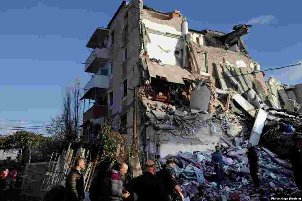 A collapsed residential building in Thumane. One person in the town reportedly died after leaping from their balcony during the quake.