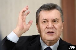 Former Ukrainian President Viktor Yanukovych answers journalists' questions during a press conference in Moscow on February 21.