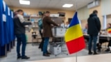 Romanian citizens vote at one of the three polling stations opened inside the "Spiru Haret" High School in Chisinau