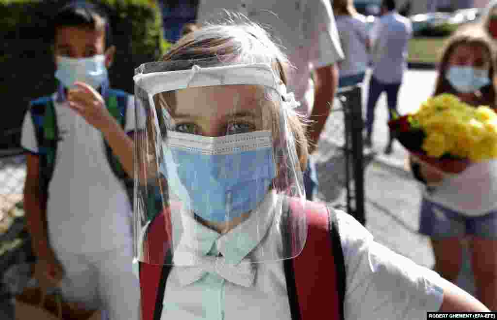 A student wearing a face shield waits to enter school during the first day back after the summer break at the George Enescu National College of Music in Bucharest, Romania, on September 14.