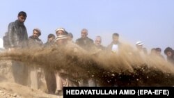 People attend the funeral of one of the victims of a suicide bomb attack in Kabul on January 28. 