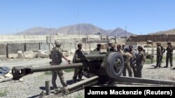 U.S. military advisers from the 1st Security Force Assistance Brigade work with Afghan soldiers at an artillery position on an Afghan National Army base in Maidan Wardak Province on August 6.