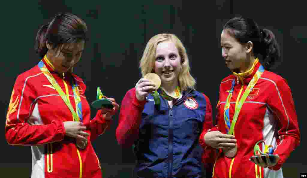 Virginia Thrasher (center) from the United States celebrates after winning the first gold medal of the Rio Games in the 10-meter air rifle competition.&nbsp;