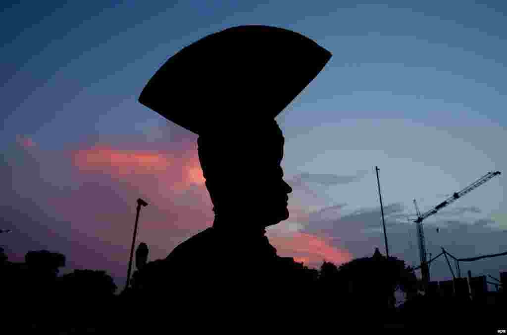 An Indian Border Security Force soldier, a member of the world's largest border-guarding force, is silhouetted against the evening sky at the India-Pakistan border in Attari. (epa/Raminder Pal Singh)