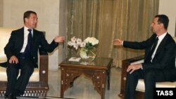 Syrian President Bashar al-Assad (right) meets with his Russian counterpart Dmitry Medvedev in Damascus on May 10.
