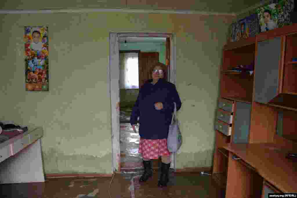 Жительница Махамбета Есенбике Жумашкалиева: &laquo;Этот саманный дом мы построили в 2004 году. Стены впитали сырость, дом может развалиться. Поселились у дочери, больше идти некуда. Сейчас живем в одном доме, три семьи&raquo;.
